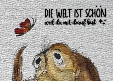 Eine Postkarte mit einem Hundemotiv und dem Spruch Die Welt ist schön weil du mit drauf bist